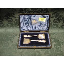 A pair of Victorian butter spades, engraved with scrolls and foliage,  the handles with scroll ca