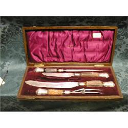 An Edwardian carving set by Walker & Hall, with silver ferrules and  horn handles, comprising car