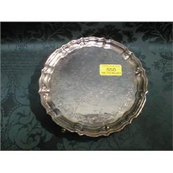 A silver waiter, with raised moulded edge, engraved centre and on 3  hoof feet, hallmark rubbed,