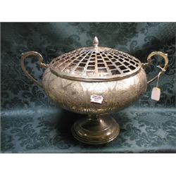 An Indian white metal rose bowl, mid 20thC.. of compressed circular  shape, embossed with trailin