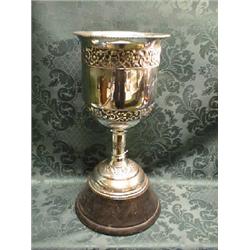 An Indian white metal racing trophy, of bucket shape, the body chased  wtih bands of flowers and