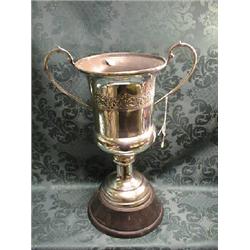 An Indian white metal 2-handled racing trophy, of campana shape,  chased with a band of flowers a