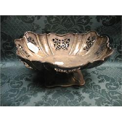 An Edward VII silver pedestal dish, the rectangular lobed bowl  pierced with scrolling panels, on