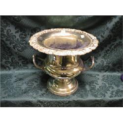 An EPNS ice bucket of campana shape, the everted rim cast with vine  and scrolls with foliate han