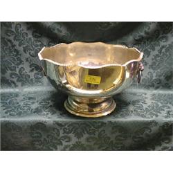 An EPNS punch bowl, with shaped and gadroon border, 2 lion mask and  ring handles, on domed foot,