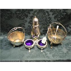 An EPNS pierced sugar basket with swing handle, on 3 bird mask and  strapwork legs with claw and