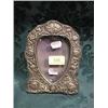 Image 1 : An Edward VII silver photograph frame, of shield shape, embossed with  putti, harebells and folia