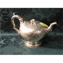 An early George III silver teapot, by Charles Wright, ovoid, the  flush hinged cover with flower