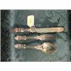 Image 1 : A Victorian child's silver knife, fork and spoon set, the handles  cast with scrolls and foliage,