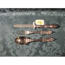 A Victorian child's silver knife, fork and spoon set, the handles  cast with scrolls and foliage,