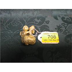 A Japanese ivory netsuke study of a cask-maker seated working upon  his latest creation.