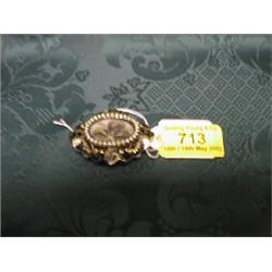 A yellow metal and black enamel memorial brooch with central hair  insert with seed pearl suround