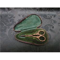 A pair of cased ornately decorated needlework scissors.