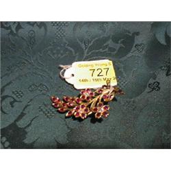 A yellow metal brooch of flower spray design set with Burmese rubies  and diamonds as flower cent