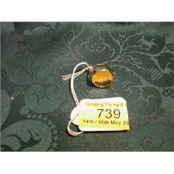 A signet ring set with a coin in 9ct gold