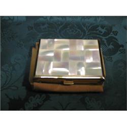 A lady's musical powder compact, rectangular, the cover decorated  with mother of pearl panels.