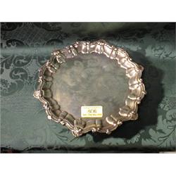 An  Edwardian style silver card tray with raised shell moulded rim on  three ball and claw feet.