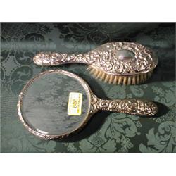 A Victorian style repousse hairbrush and mirror. Birmingham assay.