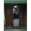 Image 1 : A Victorian mahogany triple wardrobe with central mirror door.