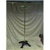 Image 1 : A pair of Victorian brass revolving coat stands with cast iron bases,  moulded with paw feet.