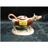 Image 1 : A Victorian Staffordshire cow creamer with tan and white body on  green sward. Illustrated on rear
