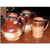 Image 1 : Two graduated Doulton Lambeth stoneware harvest jugs with Chester hallmarked silver rims, also a Dou