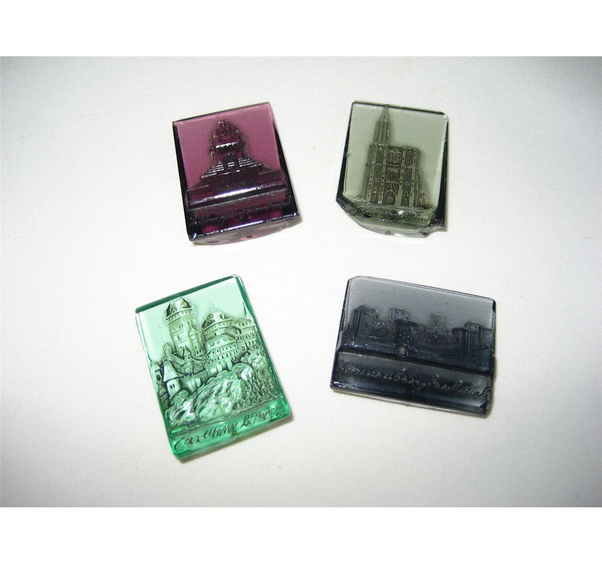 (Lot of 4) WWII German WHW Glass German Monuments tinnies ( chips to glass)