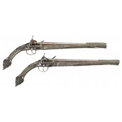 Desirable Pair of Engraved Miquelet Pistols with Silver Finished Metal Rat Tail Stocks