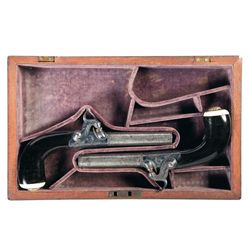 Cased Engraved Inlaid Matching Set of London Marked Damascus Barrel Percussion Muff Pistols with Ebo