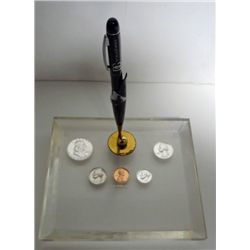 A PEN HOLDER WITH PROOF U.S. COINS FROM 1963 ENCASED IN A LUCITE BASE