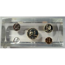 A 1959 U.S. PROOF SET ENCASED IN A LUCITE  DESK SIZE PAPERWEIGHT