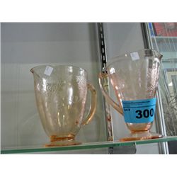 2 pink glass pitchers