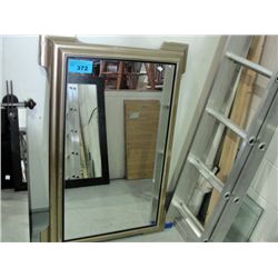 Elegantly framed hanging wall mirror