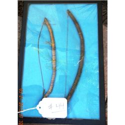 Frame with pair of miniature bows.