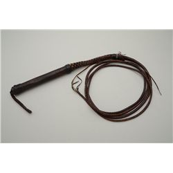 Huge leather braided late 19th to early 20th  century bull whip with tacked and green and  red cut g