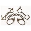 Image 3 : Lot of two old 19th century era handcuffs and  one pair of leg irons. All three are  unmarked. Show 