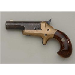 Early Colt #3 Derringer with high hammer and  curved grip. Serial number 14795. The barrel  retains 