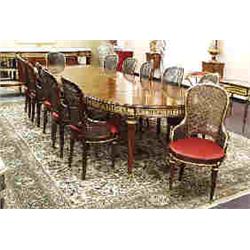 A magnificent antique French Louis XVI style fruitwood dining or boardroom table with 12 matching ar