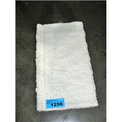 One new white bath mat