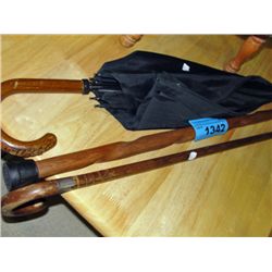 2 wooden walking sticks and an umbrella
