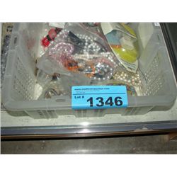 White plastic bin of assorted costume jewelry