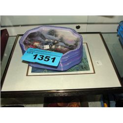 Framed loon print and stack of small decorative