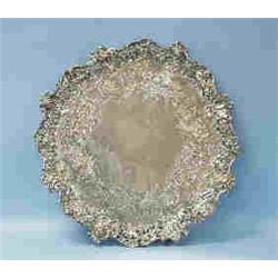 An exceptional antique Irish silver charger by Robert Scharmin. Central field decorated with floral.