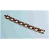 Image 1 : TIFFANY & CO - An 18kt yellow gold and red enamel bracelet. Stylized floral segments joined by red e