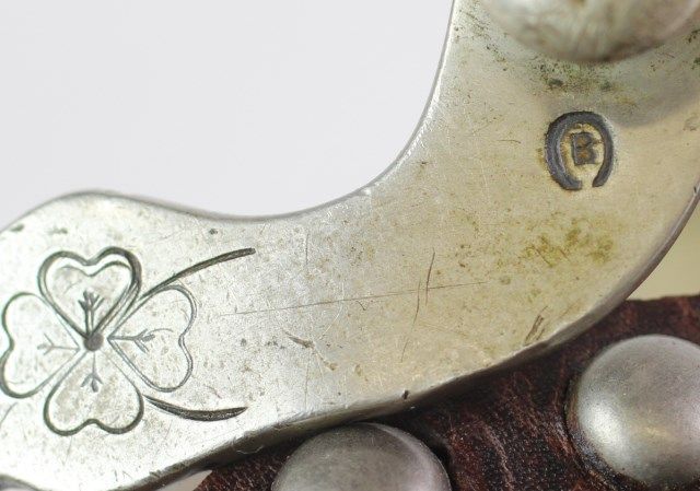 Pair iron spurs with engraved rolling logs