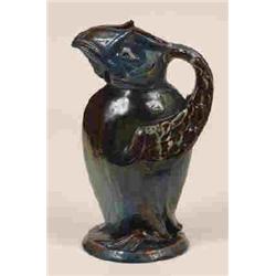 A Brannum Ware Puffin Jug, in green and blue glaze, incised and dated 1904, (slight restoration),...