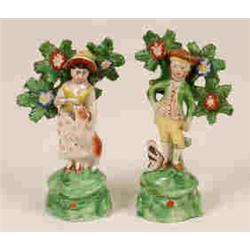A Pair of Early 19th Century Staffordshire Figures, of a Lady and Gentleman with dog companions,...