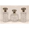 A Set of Three Cut Glass Scent Bottles, with silver mounts, decorated  scrolls and figures, Londo...