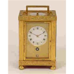 A Late 19th Century Continental Carriage Clock, the brass face with engine turned decoration havi...