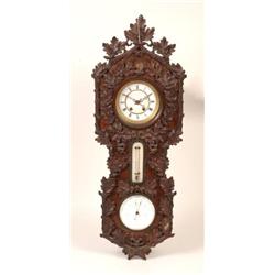 A 19th Century Wall Clock, with barometer and thermometer below, in a walnut case carved oak leav...